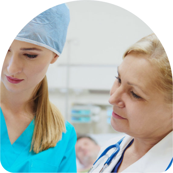 Nurse and doctor in a hospital setting reviewing patient information on a clipboard