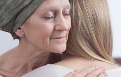 A female cancer patient hugging a female.