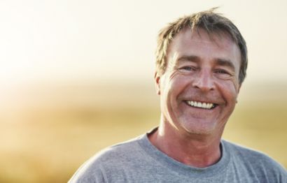 A smiling man out for a walk.