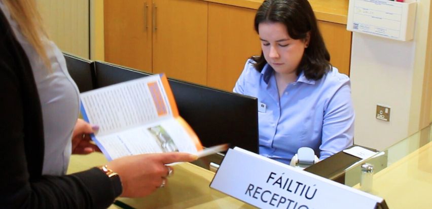 Receptionist looking at a computer