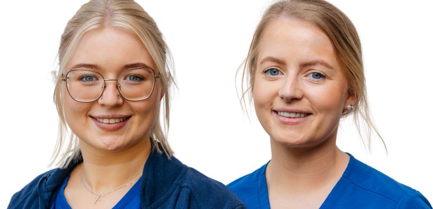 Two young blonde girls wearing blue uniforms