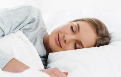 A woman smiling in her sleep.