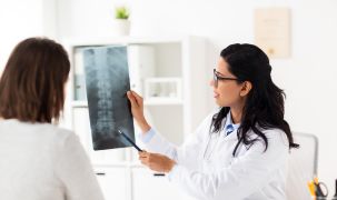 A doctor and patient looking at an X-ray scan.